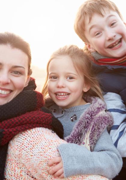 Famiglia felice all'aperto con sciarpe colorate in una giornata soleggiata.